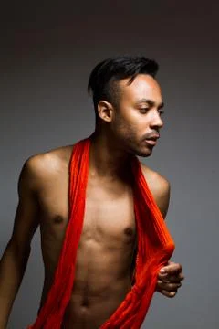 Latin man posing indoor over a grey wall. Stock Photos