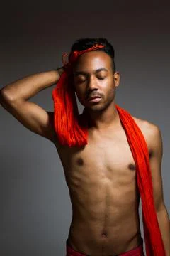 Latin man posing indoor over a grey wall. Stock Photos