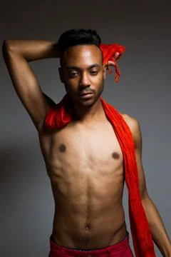 Latin man posing indoor over a grey wall. Stock Photos