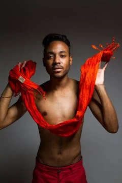 Latin man posing indoor over a grey wall. Stock Photos