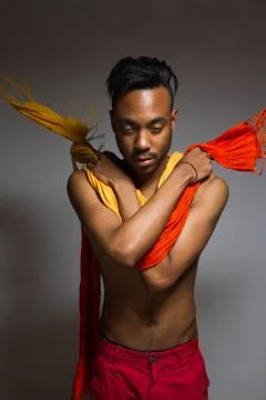 Latin man posing indoor over a grey wall. Stock Photos