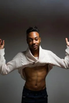Latin man posing indoor over a grey wall. Stock Photos