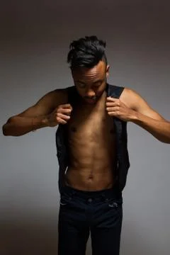 Latin man posing indoor over a grey wall. Stock Photos