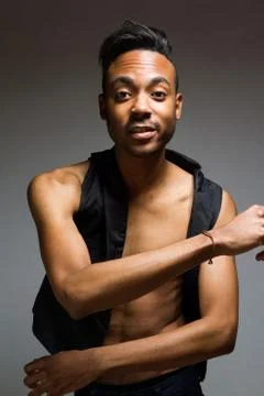 Latin man posing indoor over a grey wall. Stock Photos