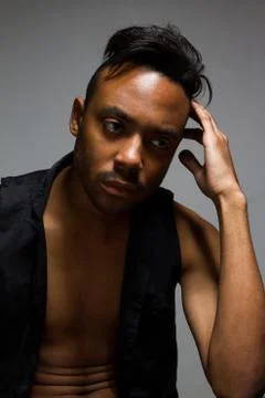 Latin man posing indoor over a grey wall Stock Photos