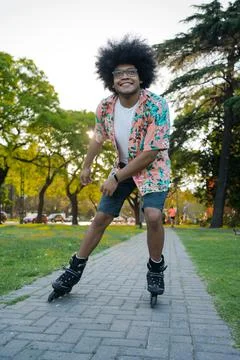 Latin man rollerskating on the street. Stock Photos