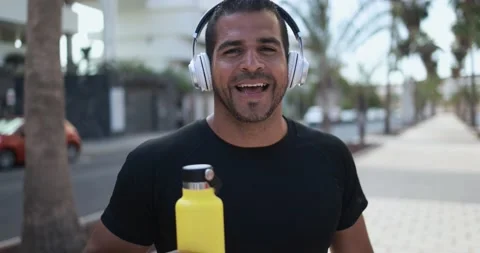 Latin man smiling in camera after sport workout in city outdoor Stock Footage 154194175