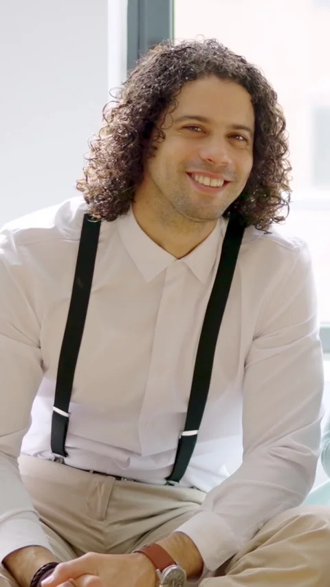 Latin man smiling at the camera sitting relaxed on coworking Stock Footage 259632509