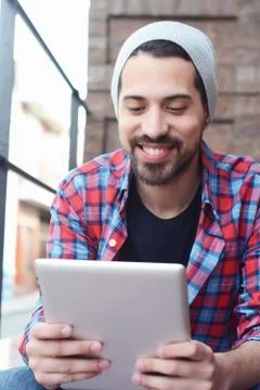 Latin man using a tablet. Fotos de archivo