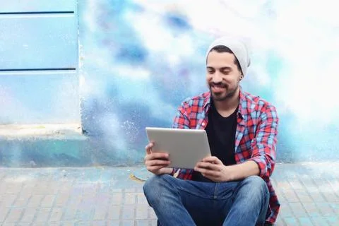 Latin man using a tablet. Stock Photos