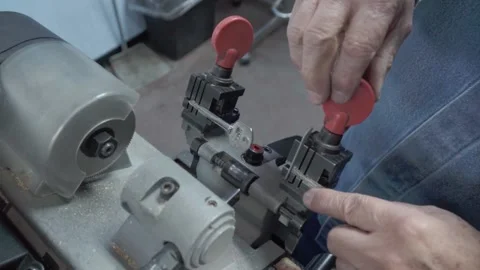 Latin man working on key duplication with special machinery. Concept of Stock Footage 276551008