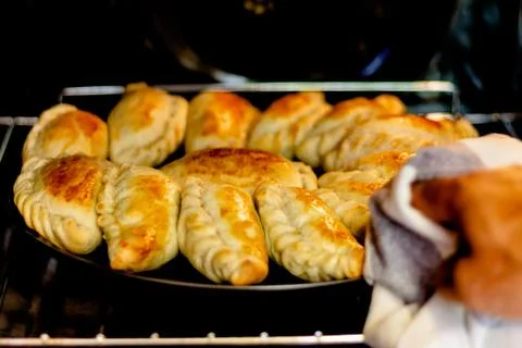 Latin man's hand preparing typical Argentine and South American pastries, "em Stock Photos