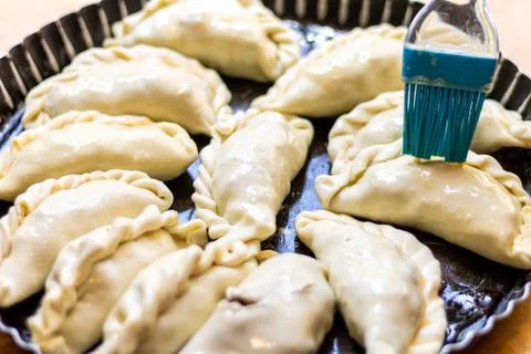 Latin man's hand preparing typical Argentine and South American pastries, "em Stock Photos