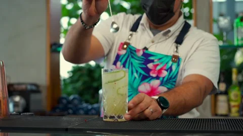 Latin mexican bartender show flair routine at preparing fresh drink at Stock Footage 247969663