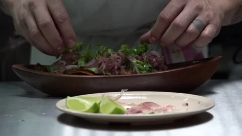 Latin mexican chef dressing topping mexico tacos with coriander red onion Stock Footage 242389019