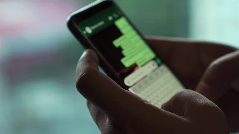 Latin or Black Man Using Smartphone While Texting in a Fast Pace. 動画素材 96544477