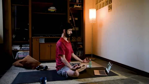 Latin performing yoga pose through online classes Stock Footage 130610753