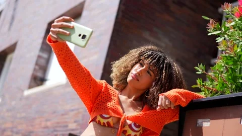 Latin student taking selfie gesturing success outside the house Stock Footage 282775671
