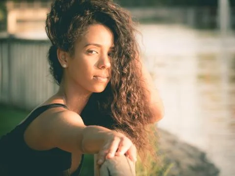Latin woman looking at camera while touching her hair Fotos Stock