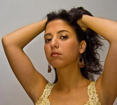 Latina with hands in hair Stock Photos