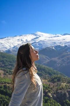 Latina woman,long hair,breathing fresh air at the top of the mountain,sierra Stock Photos