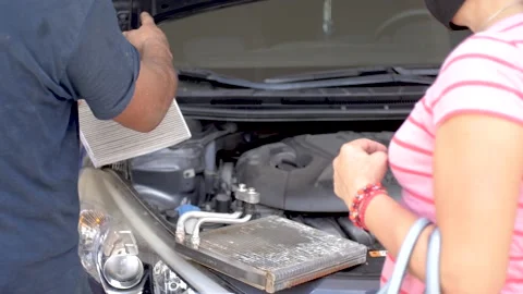 Latino Automotive Mechanic Explaining to Client Air Conditioning System Video stock 161124309