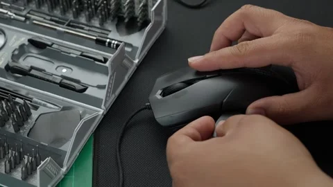 Latino man disassembling a mouse in his workshop to repair it Stock Footage 275400390