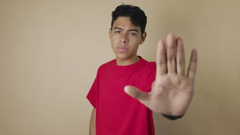 Latino man making a stop gesture with his hand and shaking his head in denial Video stock 315617768