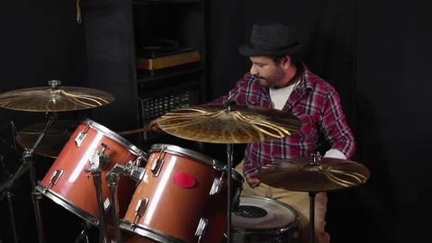 A Latino man playing the drums during a rehearsal in a practice room Stock Footage 345089230