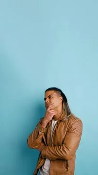 Latino man thinking contemplating solution looking up Фото