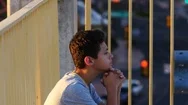 A Latino Teen Saying A Prayer In An Urban Setting Stock Footage