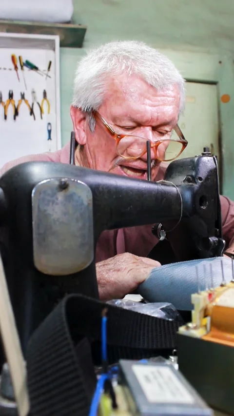 A latino upholsterer working on a sewing machine Stock Footage 304713844