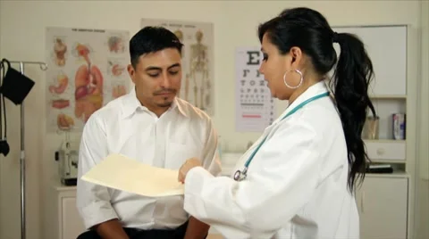 Latino woman doctor talking to paitent Stock Footage