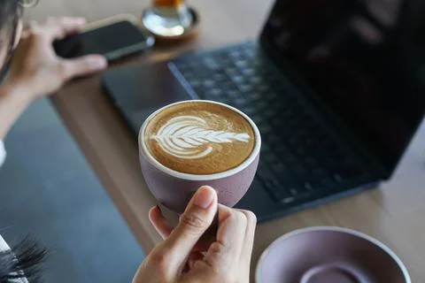 Latte and laptop on cafe table Stock Photos