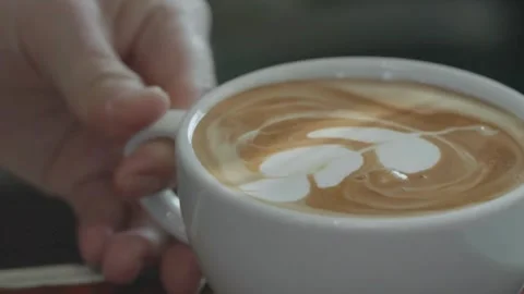 Latte art being made. Closeup video of coffee latte art making at cafe. 動画素材 334648049