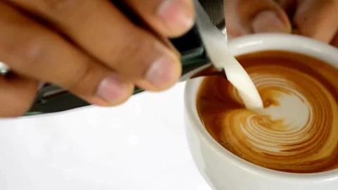 Latte art being made. Closeup video of coffee latte art making at cafe. Stock-Footage 334648344