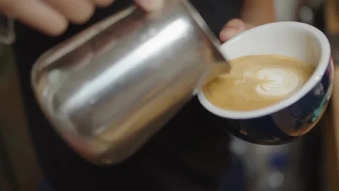 Latte art in black mug. Drinking roasted black coffee in the morning. Stock-Footage 334648508