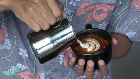 Latte art in black mug. Drinking roasted black coffee in the morning. Stock-Footage 334648521
