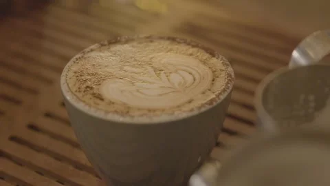 Latte Art Close-Up on Hot Beverage in Sydney Cafe, Australia, February 2016 動画素材 345698354