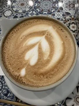 Latte Art Coffee on Decorative Patterned Table Stock Photos