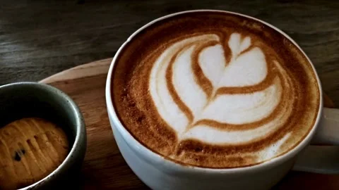 Latte art coffee ready for drink on table, overhead shot. Stock Footage 334648849