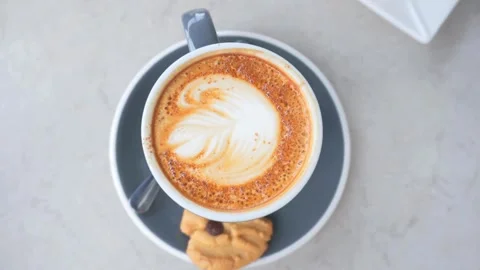 Latte art coffee ready for drink on table, overhead shot. Stock Footage 334648870