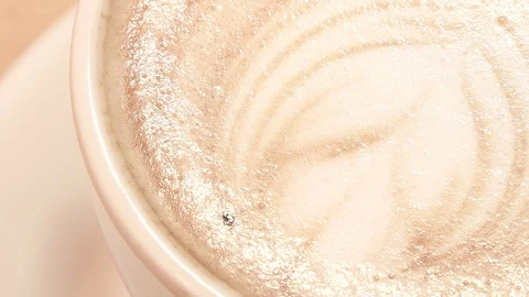 Latte art in a cup of coffee. Close up, macro, rotating shot. Stock-Footage 92992161