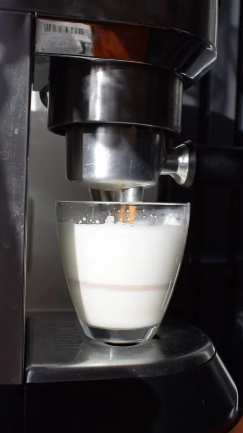 Latte being prepared in espresso machine, close up coffee making process Stock Footage 331729164