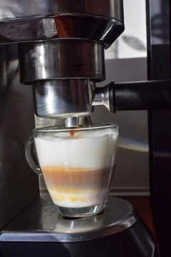 Latte being prepared in espresso machine, close up coffee making process Stock Photos