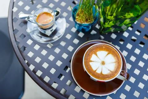 Latte coffee cup on table in cafe Stock Photos