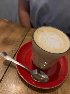 Latte with a heart pattern in a glass on the table Stock Photos