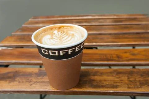 Latte with a leaf pattern on table 写真素材