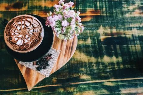 Latte on a texture table in a black cup Stock Photos