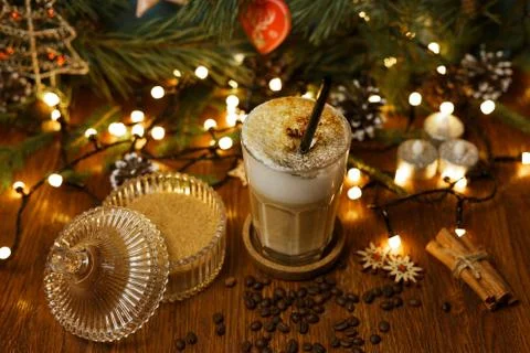 Latte with thick foam and straw arranged on wooden table 스톡 사진